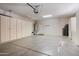 Spacious garage with ample storage cabinets and a clean, well-maintained floor at 12738 W Nogales Dr, Sun City West, AZ 85375