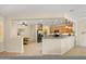 Open kitchen with stainless steel appliances, granite counters, and breakfast bar seating at 12738 W Nogales Dr, Sun City West, AZ 85375