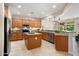 Well-appointed kitchen featuring maple cabinets, granite countertops, and stainless steel appliances at 12738 W Nogales Dr, Sun City West, AZ 85375