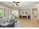 Bright and airy living room with plantation shutters, stylish furnishings, and seamless flow at 12738 W Nogales Dr, Sun City West, AZ 85375
