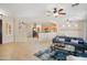Open-concept living room with seamless transition to dining and kitchen areas at 12738 W Nogales Dr, Sun City West, AZ 85375