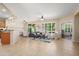 Open-concept living room featuring tile flooring, neutral decor, and ample natural light at 12738 W Nogales Dr, Sun City West, AZ 85375