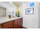 Bathroom features white countertops, wood cabinets, hardwood floors and a decorative mirror at 14037 E Coyote Rd, Scottsdale, AZ 85259