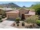 Inviting exterior view of home showcases desert landscaping, a red tile roof, and an attached garage at 14037 E Coyote Rd, Scottsdale, AZ 85259