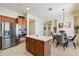 Bright kitchen features stainless steel appliances, wood cabinets, and an island with a stone countertop at 14037 E Coyote Rd, Scottsdale, AZ 85259