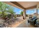 Covered patio features comfortable seating and a grill, offering an ideal outdoor entertaining space at 14037 E Coyote Rd, Scottsdale, AZ 85259