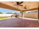 Inviting back patio featuring ceiling fans, brick pavers, and a built-in barbeque station for outdoor entertaining at 14815 N 21St St, Phoenix, AZ 85022