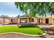 Well-maintained backyard featuring a covered patio, manicured artificial turf, and desert landscaping at 14815 N 21St St, Phoenix, AZ 85022