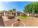 Expansive backyard with artificial turf, covered patio, built-in barbecue, fire pit and desert landscaping at 14815 N 21St St, Phoenix, AZ 85022