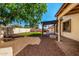 Spacious backyard with a covered patio, artificial turf, desert landscaping, and a built-in barbeque at 14815 N 21St St, Phoenix, AZ 85022