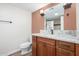 Bathroom features wood cabinets and a granite countertop at 14815 N 21St St, Phoenix, AZ 85022