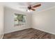 This bedroom features wood floors, a window, and a ceiling fan at 14815 N 21St St, Phoenix, AZ 85022