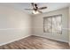 This bedroom features wood floors, neutral walls, and a ceiling fan at 14815 N 21St St, Phoenix, AZ 85022