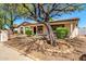 Charming single-story home featuring desert landscaping, mature trees, and a welcoming front porch at 14815 N 21St St, Phoenix, AZ 85022
