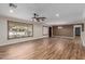 Spacious living room featuring laminate floors, a ceiling fan, and natural light at 14815 N 21St St, Phoenix, AZ 85022