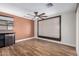 An open-concept living room with a ceiling fan, a large window, and a small refrigerator is shown at 14815 N 21St St, Phoenix, AZ 85022