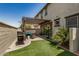 Private backyard with artificial turf, grill, and covered patio at 1635 N 208Th Ave, Buckeye, AZ 85396