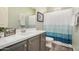 Bathroom boasts updated vanity, sink, and modern blue-themed shower curtain at 1635 N 208Th Ave, Buckeye, AZ 85396