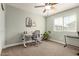 Bedroom features light green walls, ceiling fan, modern desk, and ample natural light at 1635 N 208Th Ave, Buckeye, AZ 85396