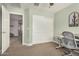 Cozy bedroom with neutral walls and carpet, featuring a desk area and closet at 1635 N 208Th Ave, Buckeye, AZ 85396