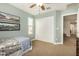 Bedroom shows carpet floor, large closet, ceiling fan, and baseball decor at 1635 N 208Th Ave, Buckeye, AZ 85396
