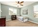 A charming bedroom with neutral carpet flooring and a ceiling fan at 1635 N 208Th Ave, Buckeye, AZ 85396