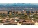View of tile rooftops with a cityscape of Phoenix in the distance and desert landscape between in an Arizona neighborhood at 1635 N 208Th Ave, Buckeye, AZ 85396