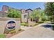 Elegant community entrance with lush greenery and a welcoming sign on a sunny day at 1635 N 208Th Ave, Buckeye, AZ 85396
