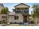 Charming two-story home featuring a cozy front porch and a balcony with a wrought-iron railing at 1635 N 208Th Ave, Buckeye, AZ 85396