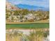 Lovely golf course with lush green and desert vegetation, set against the mountains at 1635 N 208Th Ave, Buckeye, AZ 85396