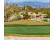 Golf course view showcasing green fairway with desert plants and mountain backdrop at 1635 N 208Th Ave, Buckeye, AZ 85396