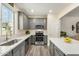 Well-lit kitchen boasting gray cabinets, stainless steel appliances, and sleek countertops at 1635 N 208Th Ave, Buckeye, AZ 85396
