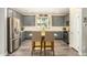 Contemporary kitchen featuring stainless steel appliances, gray cabinetry, and a central island at 1635 N 208Th Ave, Buckeye, AZ 85396