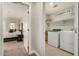 A view of the laundry room, complete with appliances, as seen from the bedroom at 1635 N 208Th Ave, Buckeye, AZ 85396