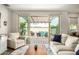 Bright living room featuring a sliding glass door and comfortable seating with an outdoor view at 1635 N 208Th Ave, Buckeye, AZ 85396