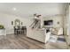 Bright living room with wood floors, ceiling fan, comfortable seating, and sliding glass doors at 1635 N 208Th Ave, Buckeye, AZ 85396