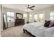Main bedroom featuring multiple windows, balcony access, and dark wood furnishings at 1635 N 208Th Ave, Buckeye, AZ 85396