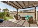 Covered patio with wicker furniture, built-in grill, and artificial turf at 1635 N 208Th Ave, Buckeye, AZ 85396
