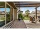 Inviting covered patio with artificial turf and seamless access from the interior at 1635 N 208Th Ave, Buckeye, AZ 85396