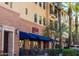 Exterior view of Grazie Pizzeria showcases blue awnings and outdoor seating area at 1635 N 208Th Ave, Buckeye, AZ 85396