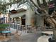 Outdoor dining area with bistro tables at Tempo features shaded seating for a relaxed atmosphere at 1635 N 208Th Ave, Buckeye, AZ 85396