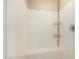 Bright shower showcasing a white surround with a built-in bench and chrome fixtures at 1635 N 208Th Ave, Buckeye, AZ 85396