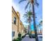 Street view along the avenue with palm trees and well-maintained buildings against a bright blue sky at 1635 N 208Th Ave, Buckeye, AZ 85396