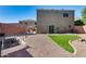 This backyard includes gravel landscaping, a strip of grass, a garden, and block wall fencing at 17606 N 17Th Pl # 1054, Phoenix, AZ 85022