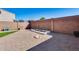 Spacious backyard with gravel landscaping, garden bed, and block wall fencing for added privacy at 17606 N 17Th Pl # 1054, Phoenix, AZ 85022