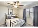 Bright bedroom featuring ceiling fan, large window, neutral walls, and soft lighting at 17606 N 17Th Pl # 1054, Phoenix, AZ 85022