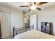 Bedroom showcasing neutral walls and carpet, featuring a ceiling fan, closet, and doorway to hallway at 17606 N 17Th Pl # 1054, Phoenix, AZ 85022