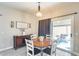 Cozy dining area with a wooden table, slider to the backyard, and neutral decor at 17606 N 17Th Pl # 1054, Phoenix, AZ 85022