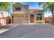 Two-story home with a two-car garage, desert landscaping, and a tile roof sits on a sunny day at 17606 N 17Th Pl # 1054, Phoenix, AZ 85022