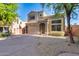 Two-story home with a two-car garage, desert landscaping, and a tile roof sits on a sunny day at 17606 N 17Th Pl # 1054, Phoenix, AZ 85022